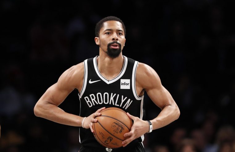 Spencer Dinwiddie in Brooklyn jersey, holding the basketball ball with both hands