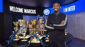 Marchus Thuram infront of Inter's trophies