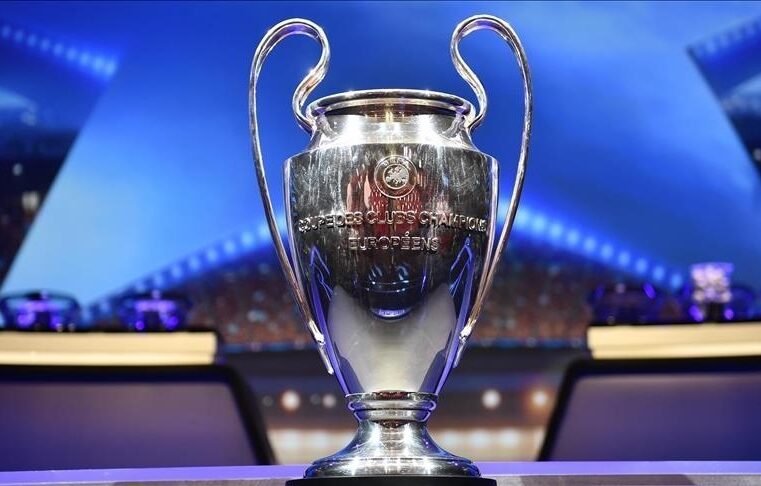 UEFA Champions league trophy on the display in front of the Champions league famous stars