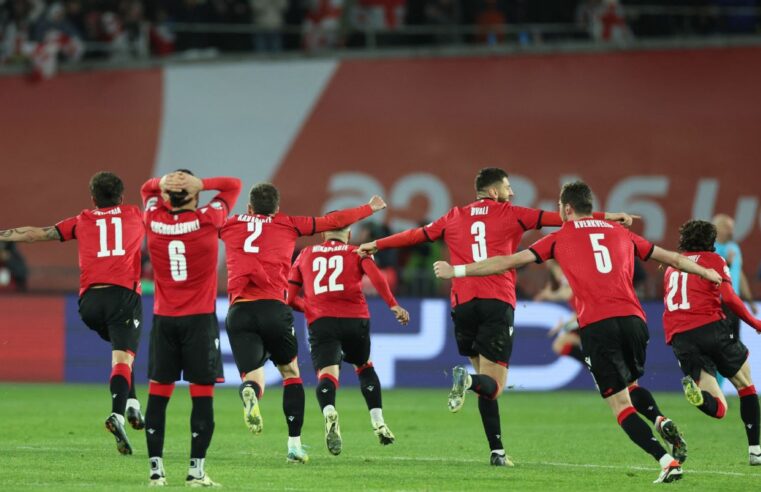 Georgia's players running in celebration of the victory and qualification to the EURO 2024